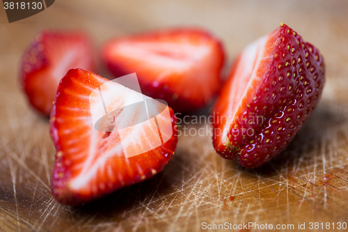 Image of close up of ripe red strawberries on cutting board