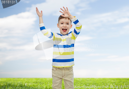 Image of happy little boy waving hands