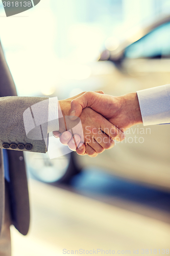 Image of close up of male handshake in auto show or salon