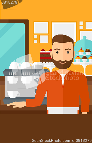 Image of Barista standing near coffee maker.