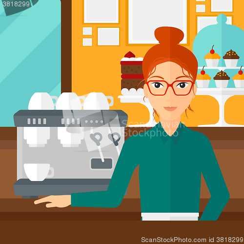 Image of Barista standing near coffee maker.