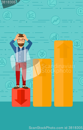 Image of Businessman standing on low graph.