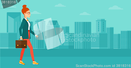 Image of Business woman walking with briefcase. 