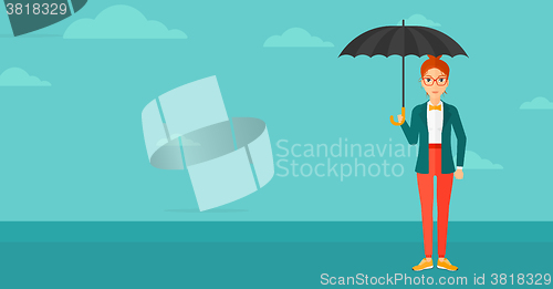 Image of Business woman standing with umbrella.