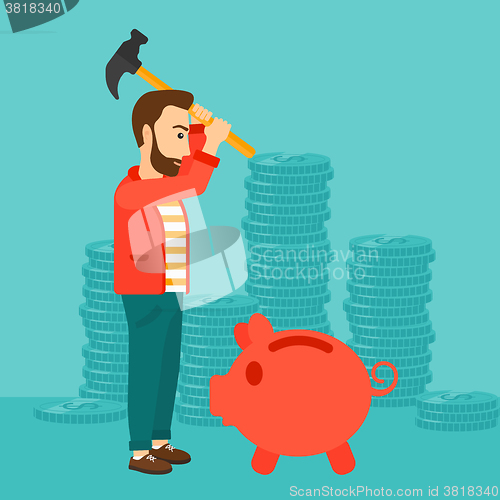 Image of Man breaking piggy bank.