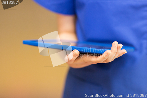 Image of close up of female doctor or nurse with tablet pc