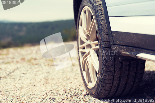 Image of close up of dirty car wheel on cliff