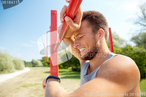 Image of man with heart-rate watch exercising outdoors