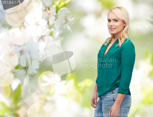 Image of smiling young woman in shirt and jeans