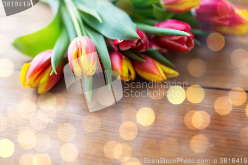 Image of close up of tulip flowers on wooden table