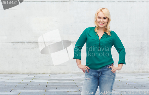 Image of smiling young woman in shirt and jeans