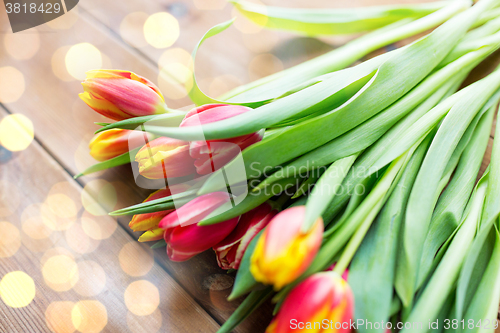 Image of close up of tulip flowers on wooden table
