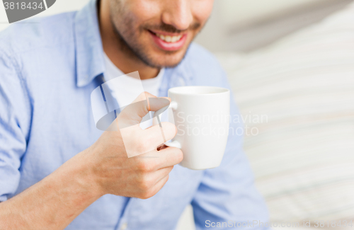 Image of close up of man with tea or coffee cup at home