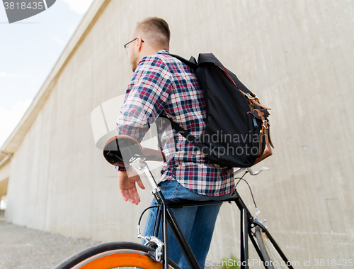 Image of hipster man with fixed gear bike and backpack