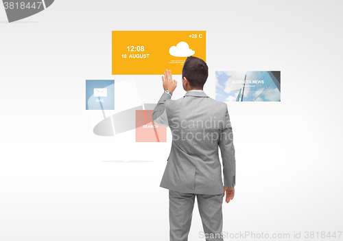 Image of businessman with virtual projection of media icons