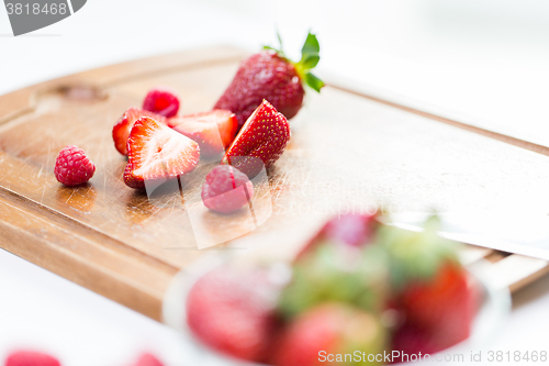 Image of close up of ripe red strawberries on cutting board