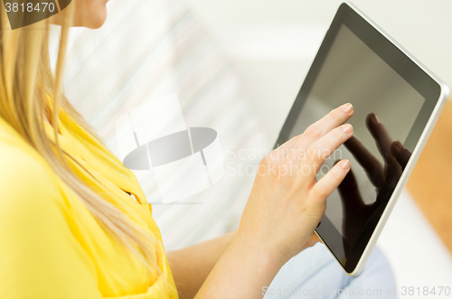 Image of close up of young woman with tablet pc at home