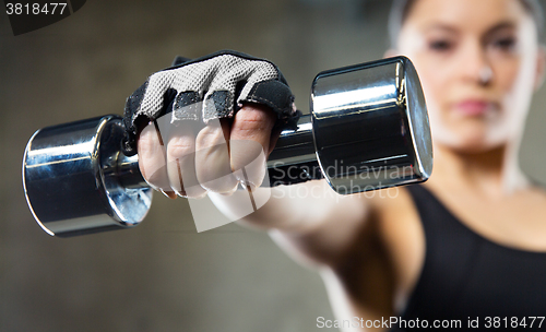 Image of close up of sporty woman with steel dumbbell