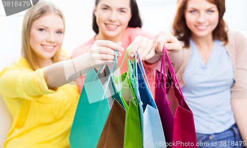 Image of close up of happy teenage girls with shopping bags