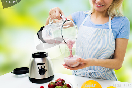 Image of close up of woman with blender and shake at home