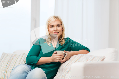Image of happy woman  with cup of tea or coffee at home