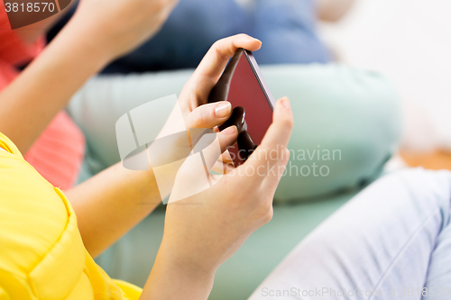 Image of close up of hands texting on smartphone at home