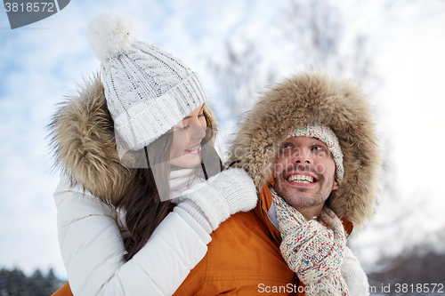 Image of happy couple having fun over winter background