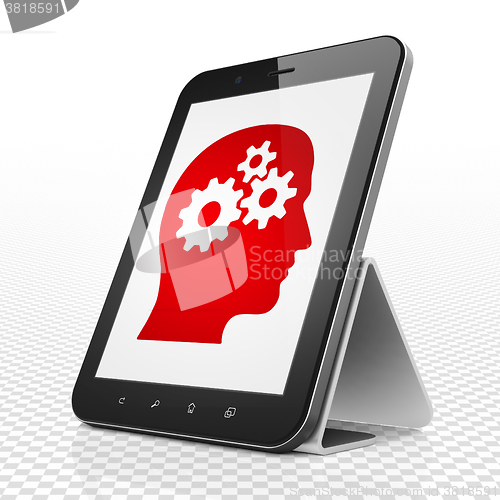 Image of Finance concept: Tablet Computer with Head With Gears on display