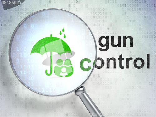 Image of Safety concept: Family And Umbrella and Gun Control with optical glass