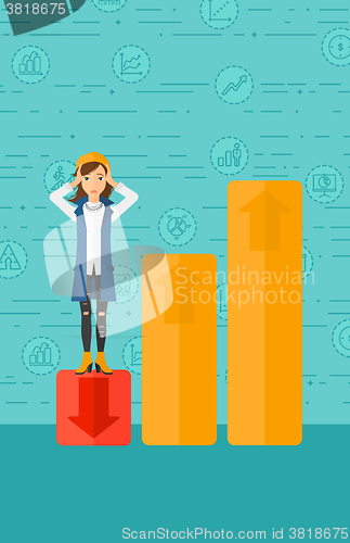 Image of Business woman standing on low graph.