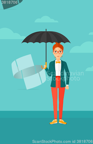 Image of Business woman standing with umbrella.