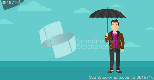 Image of Businessman standing with umbrella.