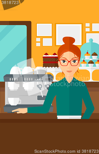 Image of Barista standing near coffee maker.