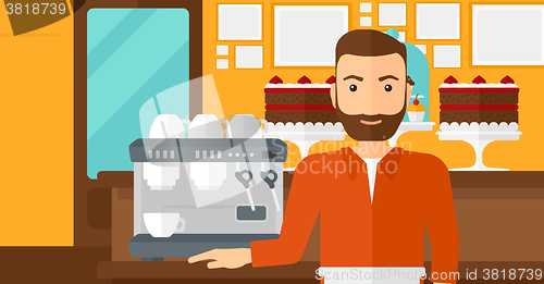 Image of Barista standing near coffee maker.