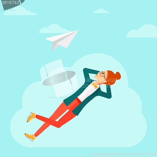 Image of Business woman relaxing on cloud.