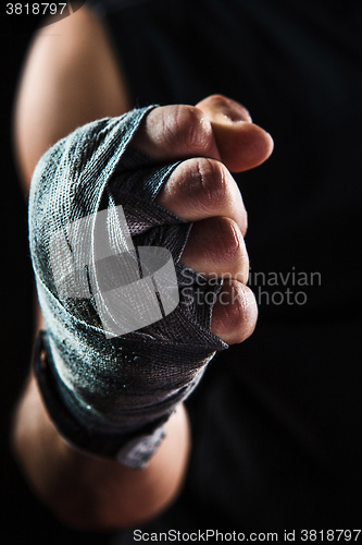 Image of Close-up hand of muscular man with bandage