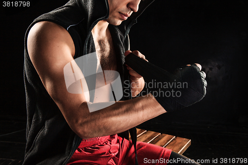 Image of The hands of muscular man with bandage