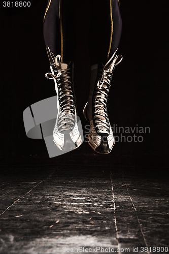 Image of The legs of muscular man with skipping rope