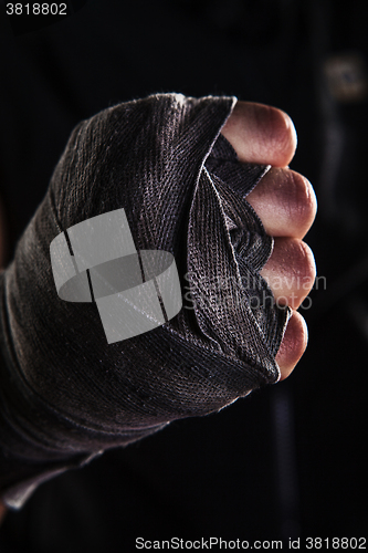 Image of Close-up hand of muscular man with bandage