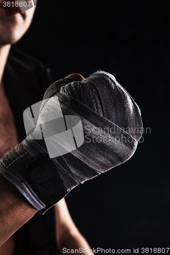 Image of Close-up hand of muscular man with bandage