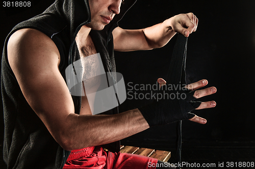 Image of The hands of muscular man with bandage