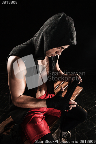 Image of The hands of muscular man with bandage