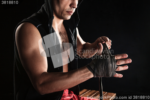 Image of The hands of muscular man with bandage