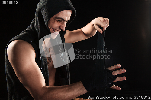 Image of The hands of muscular man with bandage