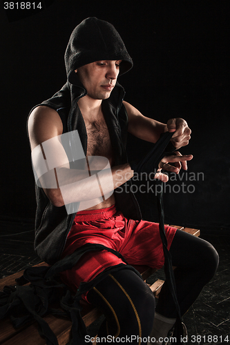 Image of The hands of muscular man with bandage