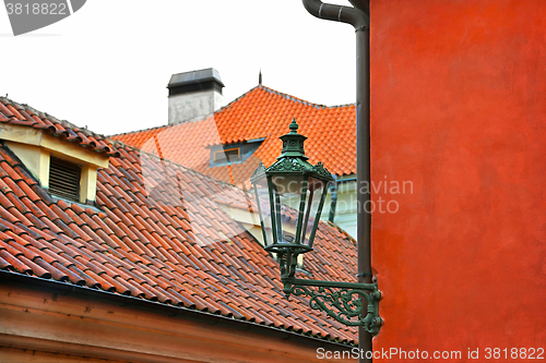 Image of Traditional street lamp and the tiled roofs of Prague