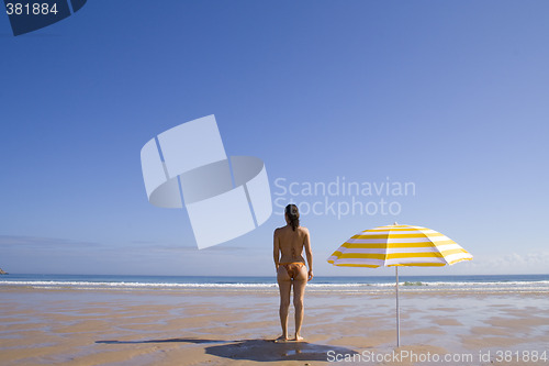 Image of Woman standing at the beach