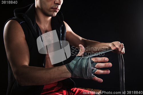 Image of The hands of muscular man with bandage