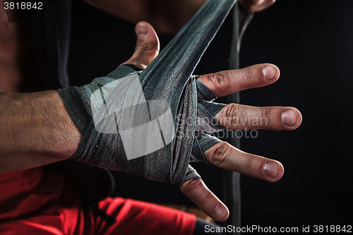 Image of Close-up hand of muscular man with bandage