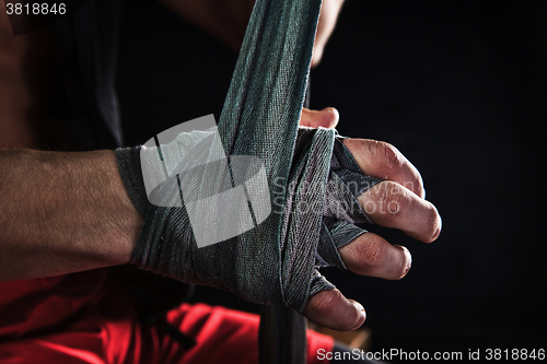 Image of Close-up hand of muscular man with bandage